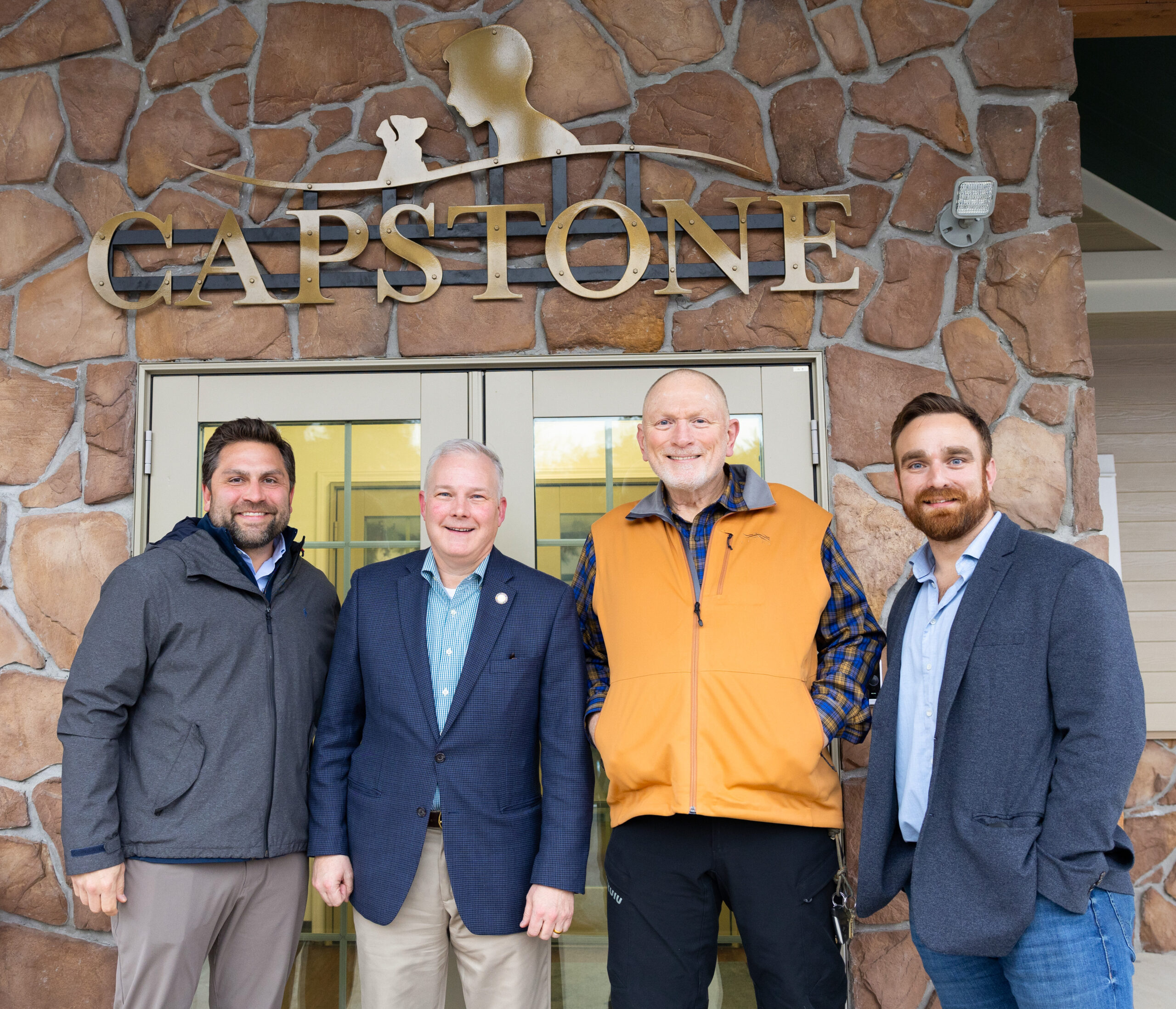 Senator Jonathan Dismang, Attorney General Tim Griffin, Dr. Adrian Hickmon, and Slade Hickmon outside Capstone Treatment Center for substance abuse grant.